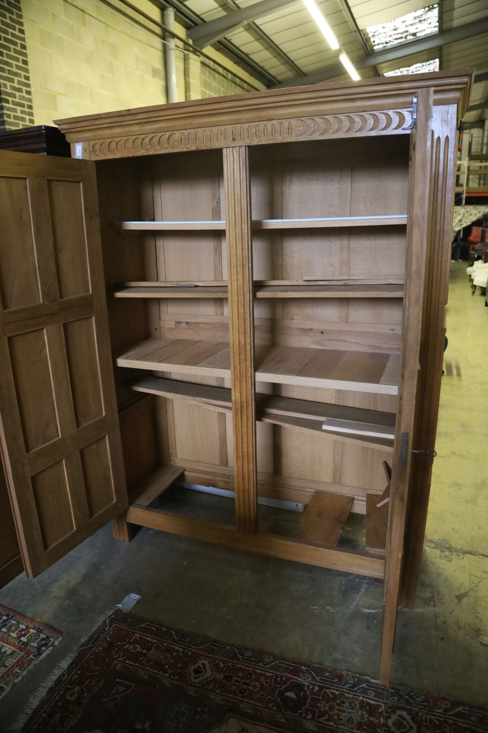 A carved and panelled oak and beech double wardrobe, width 120cm, depth 50cm, height 199cm